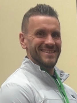 Portrait photo of Kyle Popish in a white shirt
